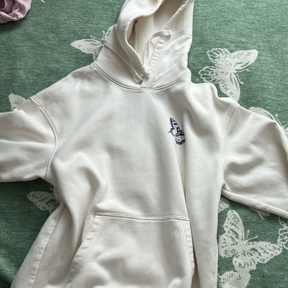 A white over sized comfy sweater with blue lettering